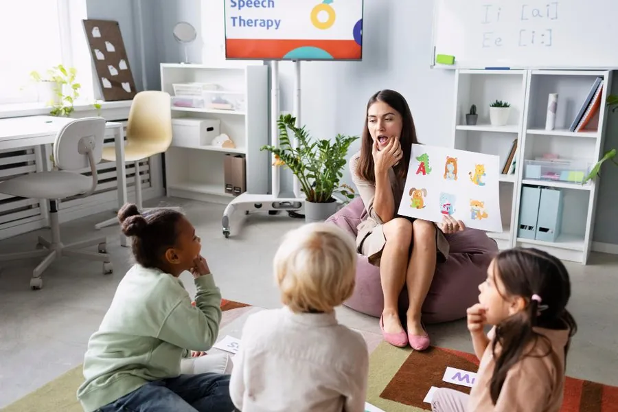 Speech therapist leading a small group session with young children