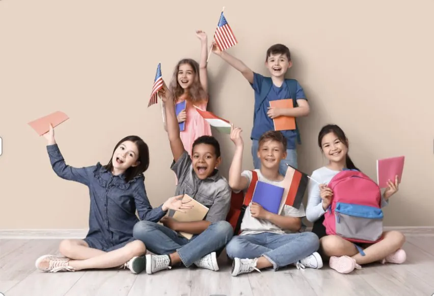Group of smiling elementary school students sitting together