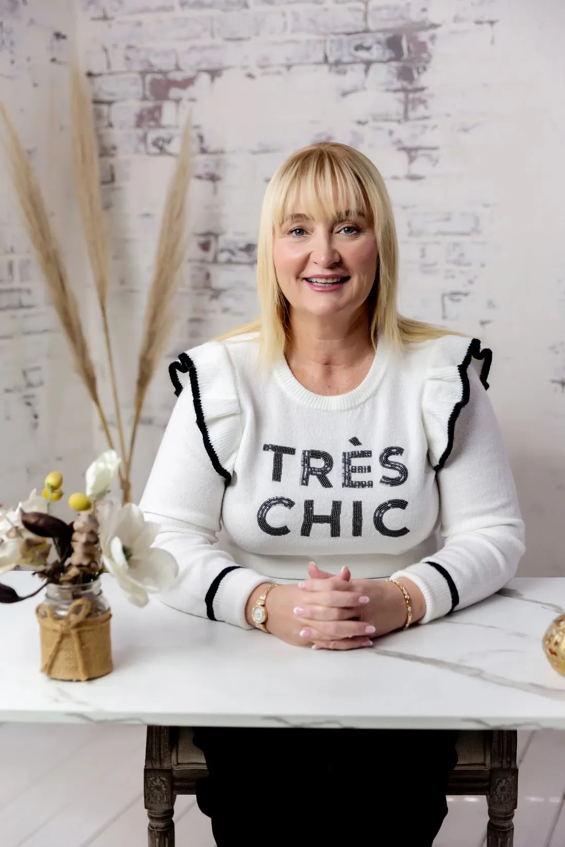 Siobhain McHale seated at a table, smiling